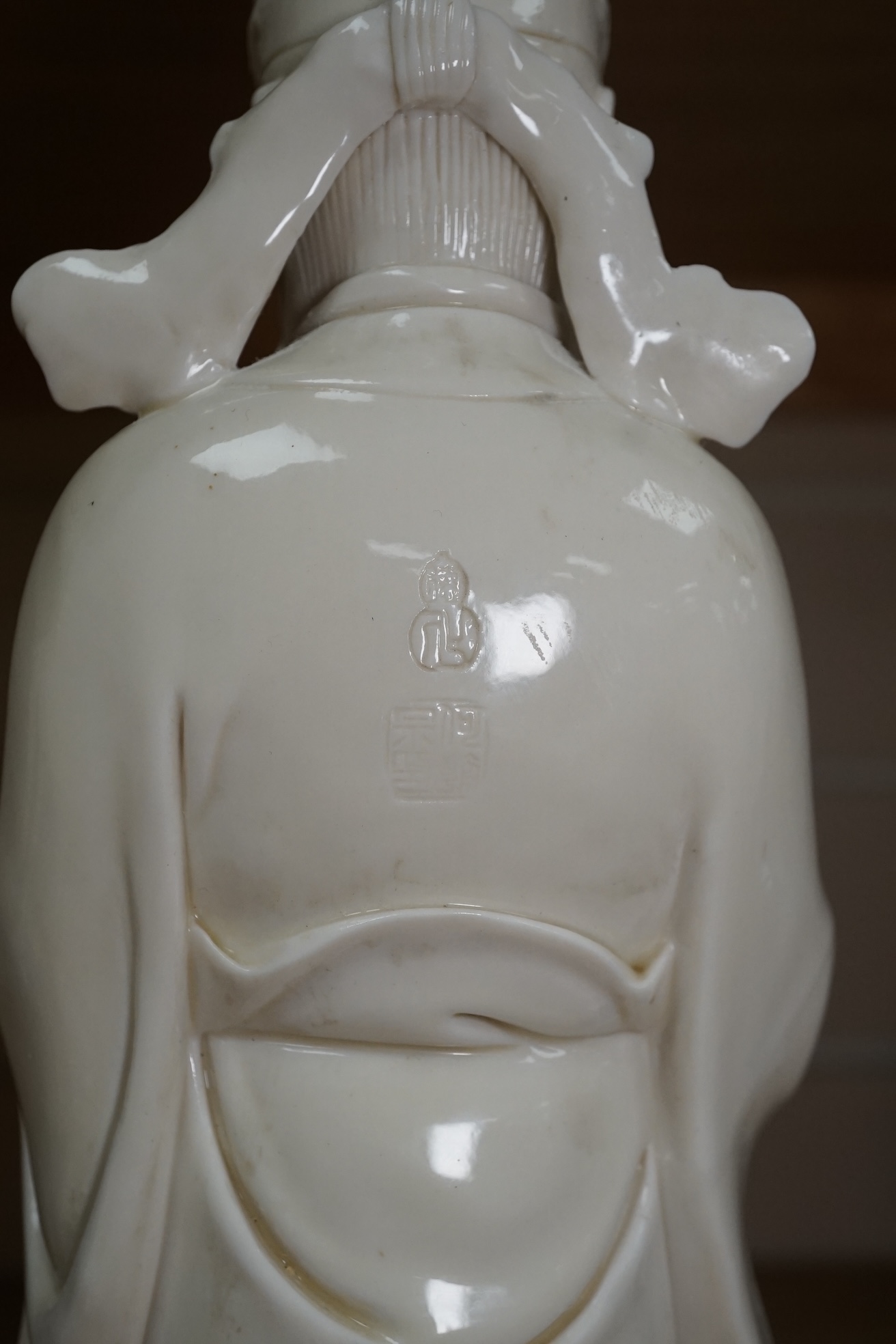 A Chinese blanc de chine Buddha figure, stamped to the reverse, 30cm high. Condition - Good